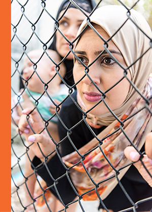refugee behind wire fence